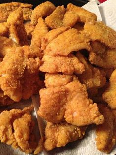 some fried food on a plate with a spoon