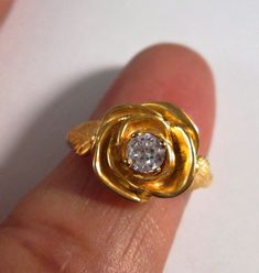 This is a beautiful hand carved 14 kt yellow gold rose ring with leaves. The center stone is a .25 ct G/H color SI1- SI2 clarity diamond. Can also be ordered in white gold, rose gold, and platinum. Comes in sizes 4.5 to 10. Delivered in a beautiful box. 100% MONEY BACK GUARANTEE Gold Diamond Jewelry With Rose Design, Fine Jewelry With Rose Design For Anniversary, Formal Gold Ring With Rose Design, Yellow Gold Flower Ring With Rose Design For Anniversary, Gold Rings With Rose Design Fine Jewelry, Gold Rings With Rose Design In Fine Jewelry Style, Anniversary Yellow Gold Flower Ring With Rose Design, Anniversary Gold Rings With Rose Design, Gold Rings With Rose Design For Anniversary