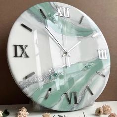 a marble clock with roman numerals on it