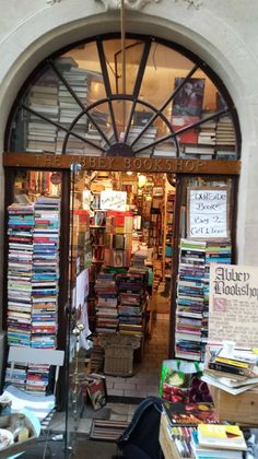 an open book store with lots of books on the shelves and in front of it