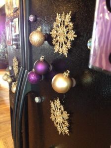 a refrigerator decorated with christmas ornaments and snowflakes