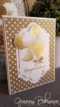 a card with gold foil flowers on it and white polka doting around the edges