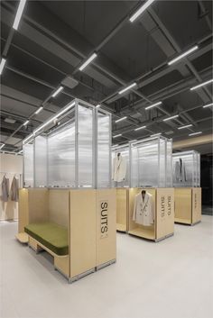 an empty room with some clothes on display