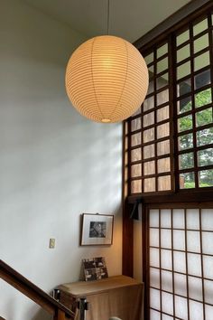 a lamp hanging from the ceiling above a table