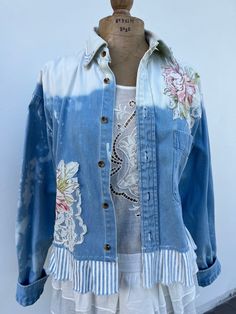 a blue jean jacket with flowers on it