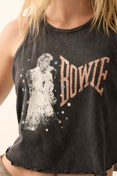 Mineral washed graphic tank top. Vintage-style David Bowie graphic print with "Bowie" text. Crew neckline. Sleeveless. Curved hem with lettuce-edge detailing. Racerback. Cropped length. Relaxed fit. 100% Cotton. Imported top designed and printed in LA. Officially licensed David Bowie merchandise. Model wears size S. Retro Stonewashed Summer Tops, Spring Band Merch Tank Top With Graphic Print, Retro Screen Print Tank Top For Summer, Edgy Letter Print Tank Top, Band Merch Graphic Tank Top For Spring, Acid Wash Sleeveless Tank Top, Acid Wash Crew Neck Tank Top For Summer, Summer Acid Wash Crew Neck Tank Top, Summer Washed Black Tank Top