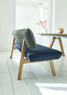 a blue chaise lounge chair sitting in front of a table