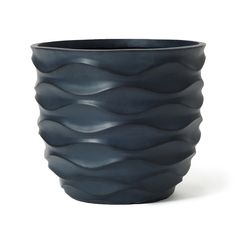 a black vase with wavy waves on the outside and inside, sitting in front of a white background