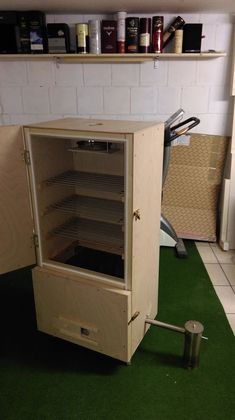 an open cabinet sitting on top of a green floor