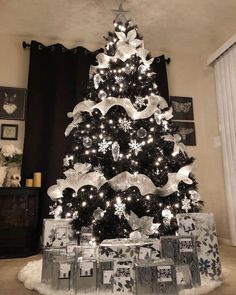 a black and white christmas tree with presents under it