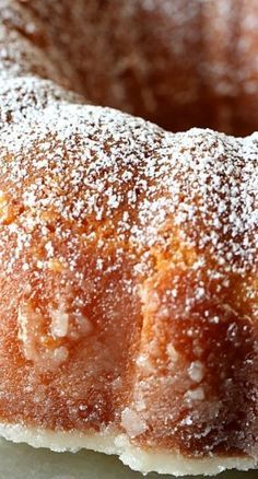 a sugar covered donut sitting on top of a white plate