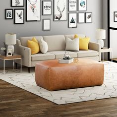 a living room filled with furniture and framed pictures on the wall above it's coffee table