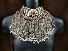 This is an Afghan kuchi tribal choker necklace. It's an old handmade Afghan Turkish banjara vintage necklace. You can not go unnoticed at any occasion while wearing it. Its a beautiful peace of art created by the tribal people, all handmade. The length of the necklace is 13 inches and with the red rope is 19 inches The height of the necklace is 7 inches from top to bottom. Please give room for some minor imperfections as its all handmade. There may be some patina also due to the age as it's a vi Bohemian Necklace With Silver Beads For Ceremonial Use, Heavy Bohemian Necklace For Ceremonial Occasions, Heavy Choker Necklace For Festivals, Silver Bohemian Choker For Ceremonial Occasions, Bohemian Heavy Choker For Festive Occasions, Traditional Silver Beaded Choker Necklace, Heavy Bohemian Choker For Festive Occasions, Traditional Boho Collar Jewelry For Festival, Traditional Choker Necklace With Silver Beads