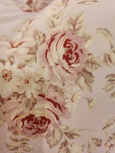 an image of a flowered fabric with red and white flowers on it's side