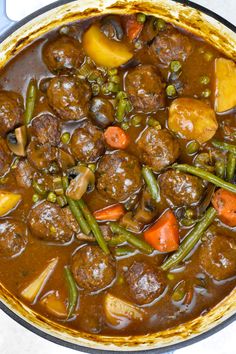 a pot filled with meat and vegetables on top of a stove