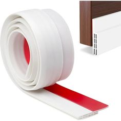 a red and white adhesivee tape next to a door with a wooden frame