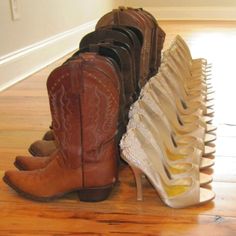 several pairs of cowboy boots sitting on top of a wooden floor next to each other