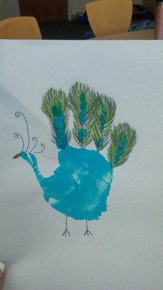 a child's drawing of a blue bird with green feathers