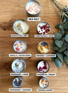 an assortment of different types of flowers and herbs in small bowls on a wooden table