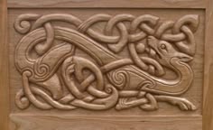 an intricate carved wood panel in the shape of a dragon