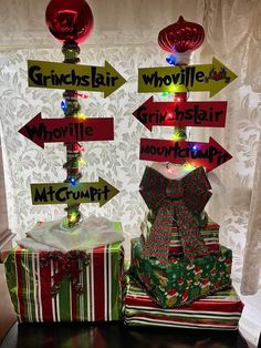 two presents are wrapped in christmas wrapping and labeled with directional signs that read grinels, whizzies, whistles, mo & mtrumpt