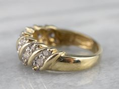 This diamond cocktail band is beautiful to behold! Rows of sparkling diamonds create a dazzling display when worn. Classic, yet stylish, this elegant ring would be perfect for an evening out or given as an anniversary gift! Metal: 14K Yellow Gold Gem: 21 Diamonds totaling .91 Carats, I2 in Clarity, J in Color Width of Band: 7.5 mm Height off Finger: 4.0 mm Ring Size: 7 Marks: "14K M" Stamped on the inside band Cocktail Ring Diamond, Jewelry Redesign, Aquamarine Cocktail Ring, Diamond Rings Design, Diamond Cocktail Ring, Diamond Cocktail Rings, Jewellery Ideas, Diamond Anniversary, Wedding Rings Vintage