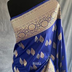 Experience timeless elegance in this blue katan silk saree, featuring sonarupa zari weaving in leaf design all over the body.  Blouse: Royal blue katan silk with zari border [unstitched] Please note there may be slight colour variations due to lighting. please send us a message if you want blouse material separated  and need pico ( no extra charge) Royal Blue Saree With Zari Weaving For Diwali, Traditional Blue Katan Silk Saree, Blue Katan Silk Saree With Traditional Patterns, Blue Katan Silk Saree With Traditional Drape, Blue Unstitched Katan Silk Saree, Blue Katan Silk Saree In Traditional Drape, Royal Blue Saree With Zari Weaving, Semi-stitched Royal Blue Saree With Zari Weaving, Royal Blue Banarasi Silk Saree With Cutdana