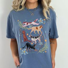 Share your Setter love with our Setter Me Up T-shirt! Let the Setter vibes flow with style. Perfect for setter lovers looking for a fun way to represent their breed anytime! Our cheery hand drawn illustration features an Irish Red & White Setter, a Gordon Setter, and Irish Setter, and two English Setters surrounded by playful florals. Want to feel the weekend vibes all week long? Our quality T's are 100% cotton and are made to last. Our T-shirts are slightly oversized for a comfy, casual look, and are garment washed for a lived in feel. Material: 100% Ring Spun US Cotton, Pre-ShrunkFit: relaxedCare: machine wash cold, tumble dry low Designed and printed in the US. We support small business, not fast fashion! **Our inclusive sizing ranges from Small to 4X-Large. Please note on larger sizes Cotton Short Sleeve T-shirt With Dog Print, Dog Print Crew Neck Graphic Tee, Trendy Crew Neck T-shirt With Dog Print, Summer Dog Print Relaxed Fit T-shirt, Summer Relaxed Fit T-shirt With Dog Print, Cotton Crew Neck Top With Dog Print, Relaxed Fit Short Sleeve Tops With Dog Print, Summer Dog Print Graphic Tee, Summer Short Sleeve T-shirt With Dog Print