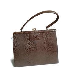 Brown Vintage bags for women. This is a vintage brown handbag. Approximately 1960-1965years. In a very good condition. Metal Stainless Steel Fittings. Coffee brown bag Dimensison: height 20 cm (8 inches)  width 25 cm (10 inches)  thickness 8 cm (3 inches)  length of the handle 35 cm (14 inches)   Vintage bagsfor womenBrown handbags60s kelly bagReptile handbag Reptile PurseEveryday bagTop Handle Bagssmall leathershoulder bagsClassic bagKelly stylesimple handbag Retro Brown Box Bag For Everyday, Vintage Brown Square Bag, Vintage Brown Rectangular Shoulder Bag, Retro Vintage Brown Rectangular Shoulder Bag, Vintage Brown Shoulder Bag For Office, Vintage Square Formal Bags, Vintage Brown Rectangular Bag, Brown Mid-century Evening Bags, Brown Retro Rectangular Box Bag