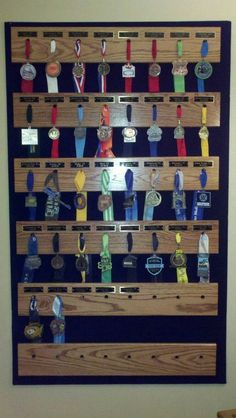 a wall mounted display with many medals on it