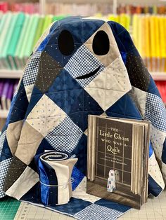 a stuffed animal sitting on top of a table next to a book and an object