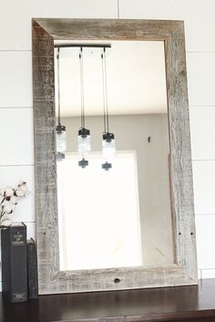 a mirror sitting on top of a wooden dresser