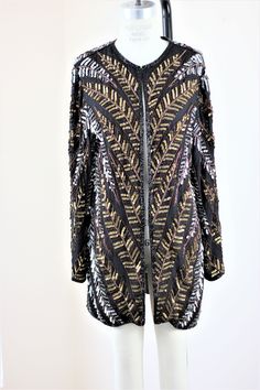 "Formal Sparkle Duster type jacket, long with loads of sequins that look like feathers or leaves. Matching Bronze or silver this can be used for all kinds of things. Over jeans, over a black dress...great duster style.. Excellent Measuring: 32\" length Width: 40\" Sleeves: 23\" Pet Free/smoke free Enjoy!" Feathered Long Sleeve Party Outerwear, Bohemian Style Embellished Outerwear For Party, Beaded Fall Festive Outerwear, Bohemian Party Outerwear With Sequins, Bohemian Embellished Party Outerwear, Festive Beaded Fall Outerwear, Bohemian Long Sleeve Party Outerwear, Glamorous Beaded Party Outerwear, Beaded Party Dress