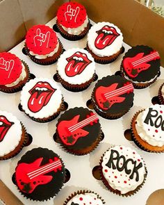 a box filled with cupcakes decorated like the rolling stones