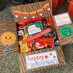 two boxes filled with halloween treats on the ground