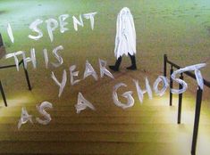 a person walking up some stairs with writing on them that says it spent this year as a ghost