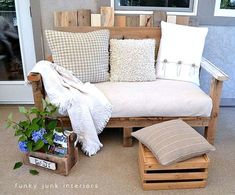 a couch made out of wooden pallets and pillows