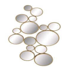 a group of mirrors sitting on top of a white wall next to each other in the shape of circles