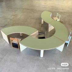 an oval shaped table with two chairs in the middle and one chair at the end