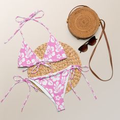 Indulge in the luxurious and exclusive style of our White Hawaiian Flowers on Pink String Bikini. This beautiful string bikini set is not only comfortable, but it also offers double-layering and UPF 50+ protection. Customize the straps to your liking and get ready to turn heads at the beach! Made from soft recycled polyester, this bikini is both stylish and sustainable. • Soft and stretchy material with UPF 50+• Sizes up to 6XL• Bikini top comes with removable padding for comfort• Multiple ways White Hawaiian Flowers, White Bikinis, Hawaiian Flowers, Small Tops, Upf 50, Stretchy Material, At The Beach, String Bikinis, The Beach