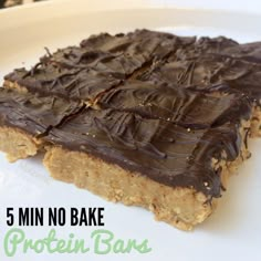 a close up of a plate of food with chocolate frosting on it and the words, 5 min no bake protein bars