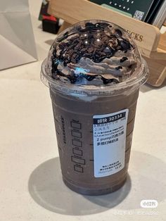 a plastic cup filled with ice cream on top of a table