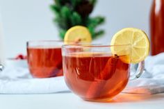 two glasses filled with tea and lemon slices