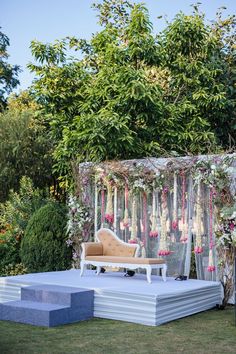 an outdoor ceremony setup with flowers and greenery