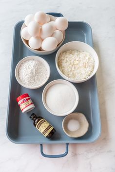 eggs, flour and other ingredients on a blue tray