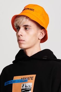 Bucket hat in orange featuring black Chrome Galaxy logo embroidery in the front. Solid Color Short Brim Bucket Hat For Streetwear, Curved Brim Bucket Hat For Streetwear, Casual Bucket Hat With Logo Patch And Short Brim, Casual Solid Color Hats With Logo Patch, Casual Orange Short Brim Hats, Casual Bucket Hat With Logo Patch And Curved Brim, Solid Curved Brim Bucket Hat For Streetwear, Orange Bucket Hat For Outdoor Use, Casual Orange Bucket Hat With Short Brim