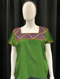 This is one of a kind Huipil or top handmade in Nebaj Quiche, Guatemala. It is lightweight and very comfortable to wear. The colors and design on the top are stunning. Pair with shorts or jeans for a casual look. Green Blouse With Floral Embroidery And Relaxed Fit, Relaxed Fit Multicolor Embroidered Tops, Green Embroidered Crew Neck Blouse, Green Blouse With Embroidered Neckline, Green Embroidered Relaxed Fit Blouse, Green Embroidered Blouse With Relaxed Fit, Green Crew Neck Blouse For Vacation, Traditional Green Embroidered Tops, Casual Green Embroidered Cotton Top