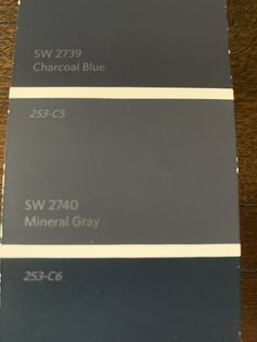 some gray and white paint samples on a table