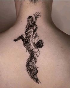 a man with a dragon tattoo on his back