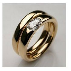 two gold wedding bands with a diamond in the center and on each band, set against a white background